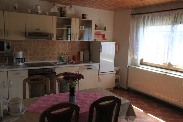 Dining table and kitchenette with stove, oven and sink